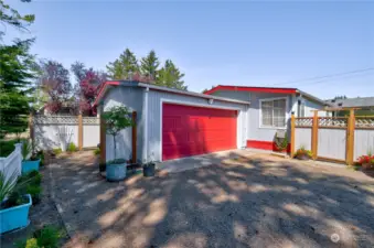 large finished garage with work benches and wall heaters. freezer and refrig stay.