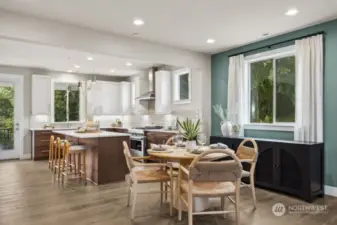 Light and bright dining area looks to the large, modern kitchen with modern touches throughout!