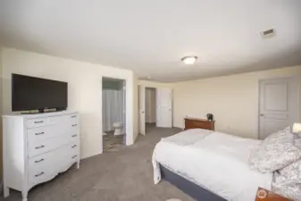Primary bedroom looking towards bathroom and walk in closet