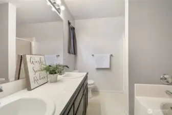 Primary bathroom with dual sinks, separate shower and soaking tub