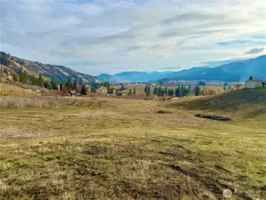 current photo looking across vast lands ready for development.  this view looking SE across project with valley views