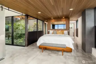 Primary bedroom suite with private balcony showcasing water views