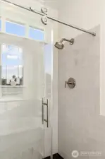 Main shower with zero entry and elegant sliding glass door