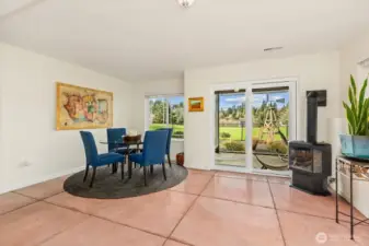 Daylight basement opens up to the fenced space for pets or an evening relaxing by the fire