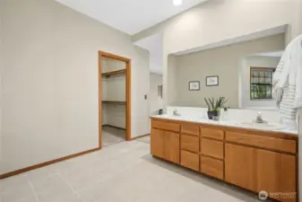 Primary bathroom tile floor and door to walk in closet