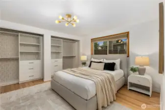 The generous primary bedroom features custom built-in closets that come with a lifetime warranty and a wall A/C unit to keep cool during those summer months