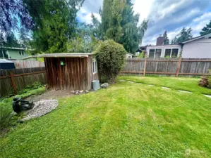 Level backyard with custom built child's playhouse.  Use this space to play or additional storage- options are unlimited!