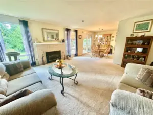 Spacious living room opens to dining and backyard with covered patio.