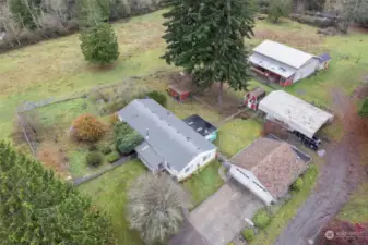 Fully fenced and ready for your horses or livestock, this property features a spacious barn, a two-car garage, a large carport, and multiple outbuildings for extra storage.