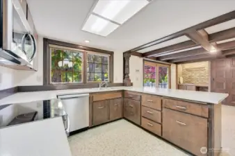 Large kitchen features new stainless steel appliances, breakfast bar and large eating area