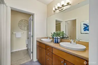 En-suite bathroom, double sink to the right, walk-in closet to the left, plus shower.