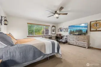 Primary Bedroom with large picture window facing West. See those mature trees, changing color as fall works her magic? Absolutely gorgeous.