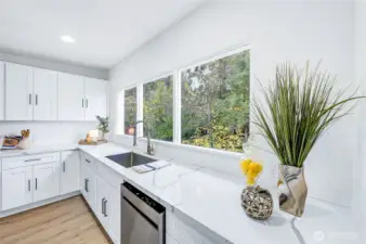 The large windows in the kitchen let the natural light pour in.