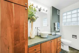 The main floor bath has the classic mid-century touches like the glass block window.
