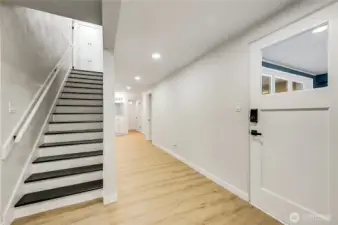 The extra wide hallway leads to two more large bedrooms and 3/4 bath. The door on the right goes out to the large covered patio.