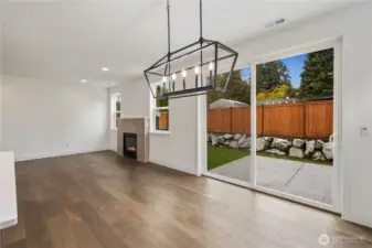 Dining to Great Room:  The dining area seamlessly flows into the great room, with large sliding glass doors inviting views of the landscaped rockery and fully fenced backyard. This open layout allows you to host with ease while maintaining clear sightlines across the main living spaces. Surrounded by the greenery and convenience of Bothell’s Canyon Park neighborhood, the home sits moments from local trails, community parks, and key commuter routes. The modern chandelier, wide-plank floors, and natural light combine to create a bright, welcoming space that adapts beautifully to everyday life.    These photos are from Lot 5 at Gooden Hollow, which is the same floorplan, but a different home than listed here. However, other homes in the community will have changes, so all photos, renderings, site maps, and floorplans are for visualization purposes only. Plans, colors, building orientation, finishes, home outlook, and other details can and WILL vary.