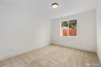 Main-Level Guest Bedroom:  Generous natural light fills this main-level bedroom, highlighting the fresh neutral palette and soft carpeting that creates a comfortable retreat. Its location just steps from the main-floor bath supports flexible living arrangements, offering privacy and accessibility for many lifestyle needs. Nestled within Bothell’s Canyon Park area, the home places you near local recreation, Northshore schools, and easy commute options along I-405. This room adds valuable versatility to the floorplan, enhancing both daily convenience and guest comfort.    These photos are from Lot 5 at Gooden Hollow, which is the same floorplan, but a different home than listed here. However, other homes in the community will have changes, so all photos, renderings, site maps, and floorplans are for visualization purposes only. Plans, colors, building orientation, finishes, home outlook, and other details can and WILL vary.