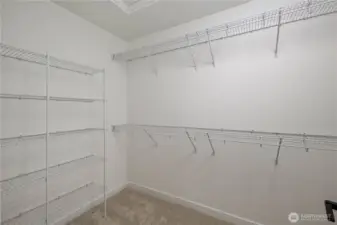 Primary Walk-In Closet:  The walk-in closet offers extensive built-in shelving and hanging space, creating an organized extension of the primary suite. Its layout maximizes capacity while keeping everything within easy reach. Thanks to the home’s location in Bothell’s Canyon Park area, the suite benefits from a peaceful residential environment close to shopping, cafés, and community conveniences. This well-sized closet adds everyday ease and helps maintain the calm, uncluttered feel throughout the suite.    These photos are from Lot 5 at Gooden Hollow, which is the same floorplan, but a different home than listed here. However, other homes in the community will have changes, so all photos, renderings, site maps, and floorplans are for visualization purposes only. Plans, colors, building orientation, finishes, home outlook, and other details can and WILL vary.