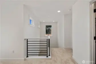 Landing / Upper Hallway:  This open upper landing is bright and inviting, framed by elevated windows that pull in natural light while maintaining privacy. The wide hallway makes the second floor feel connected and easy to navigate, creating a smooth transition between the bedrooms, loft, and primary suite. Its position in Bothell’s Canyon Park area places you minutes from local trails, shops, and the Eastside commuting corridors. Clean modern railings and soft, neutral finishes help the space feel calm and contemporary.    These photos are from Lot 5 at Gooden Hollow, which is the same floorplan, but a different home than listed here. However, other homes in the community will have changes, so all photos, renderings, site maps, and floorplans are for visualization purposes only. Plans, colors, building orientation, finishes, home outlook, and other details can and WILL vary.