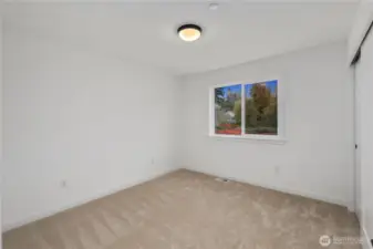 Secondary Bedroom (Rear-Facing View):  This peaceful upper-level bedroom offers a serene treetop outlook framed by a wide window, along with plush carpeting and crisp white walls that keep the space feeling airy and open. Its balanced proportions make it versatile for a range of uses, with plenty of room to arrange furnishings comfortably. With the home situated near Bothell’s wooded greenbelts and nearby Northshore trails, the setting brings a quiet Pacific Northwest backdrop into everyday living. Its understated finishes create a calming environment that supports both productivity and relaxation.    These photos are from Lot 5 at Gooden Hollow, which is the same floorplan, but a different home than listed here. However, other homes in the community will have changes, so all photos, renderings, site maps, and floorplans are for visualization purposes only. Plans, colors, building orientation, finishes, home outlook, and other details can and WILL vary.