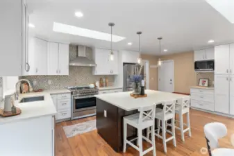 Gourmet kitchen with quartz counters, stainless appliances, and a large center island.