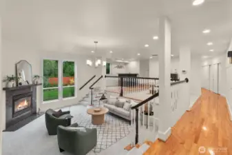 Light-filled living room with large windows and warm hardwood flooring