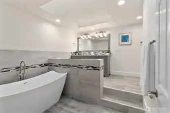 Luxurious, updated primary bath with modern finishes and generous storage.