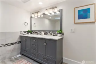 Luxurious, updated primary bath with modern finishes and generous storage.