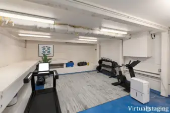 Lower-level family room with space for media, games, or play. Dedicated exercise/hobby room with separate access under the deck.