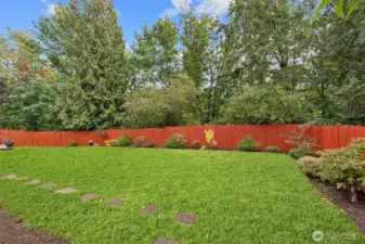 Side yard with easy access around the home and additional outdoor space.