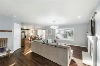 The great room is spacious and features a picture window overlooking the lake and giving the feeling that you live in a tranquil treehouse