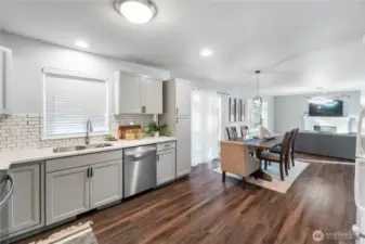 The kitchen features upgraded, soft-close cabinets & drawers with decorative pulls and an inlaid stainless sink & faucet