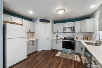 Stainless steel appliances shine up the space and the refrigerator is included