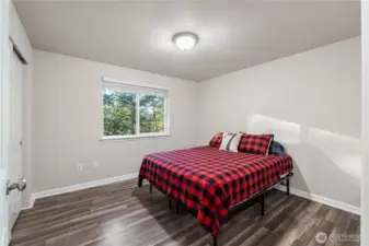 The upper bedroom overlooks the trees and lake. Both bedrooms have been freshly painted including the base trim and all the rooms offer faux wood blinds