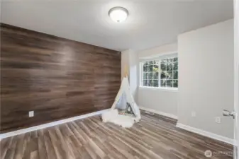 The other upper bedroom has a fun accent wall and the upstairs also offers low maintenance laminate flooring throughout