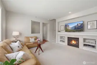 Formal entry foyer leads to gracious living room with built-in's and cozy gas fireplace.