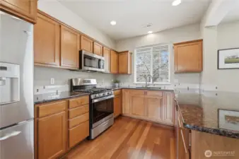 Stunning kitchen with new stainless-steel range/oven & microwave, plus plenty of cabinet space & slab granite countertops with eating bar.