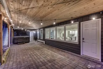 Patio under the deck with direct access to the downstairs family room and outside hot tub.