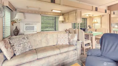 Spacious couch for relaxing, plus an A/C unit that keeps the space cool and is included with the home.