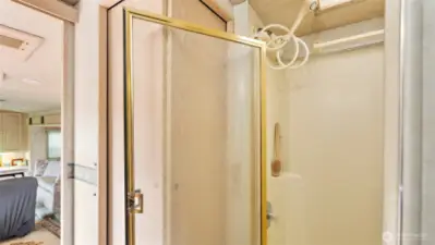 The shower features a high-mounted showerhead, providing plenty of clearance so there’s no need to duck.