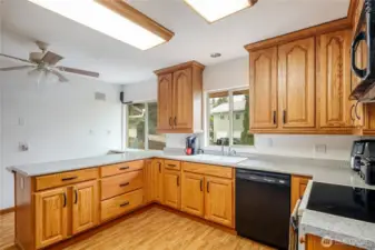 The kichen has hardwood flooring, lots of cabinetry and working space. Refrigerator stays.