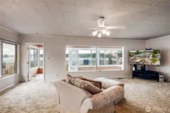 Spacious living room with fabulous views of the lake. Attached sun room.