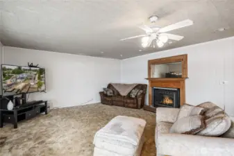 The living are has a propane fireplace with a gorgeous, wood mantle.