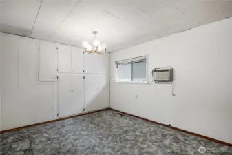 Guest bedroom with full wall built in wardrobe closets.