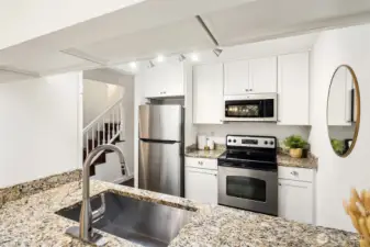 Updated kitchen with granite counters and stainless steel appliances.