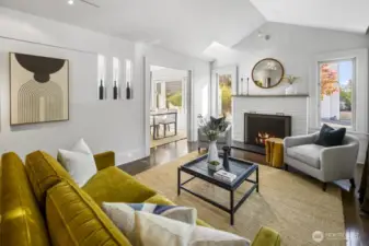 Light-filled living with vaulted ceiling and fireplace; open to dining for seamless entertaining.