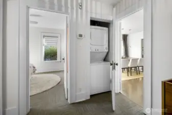 Hall laundry closet centrally placed between bedroom and dining for convenience.