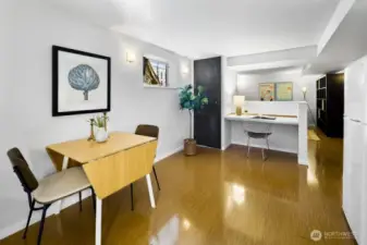 Lower level studio open dining/work zone beside the kitchen—space for a table plus a dedicated desk nook.
