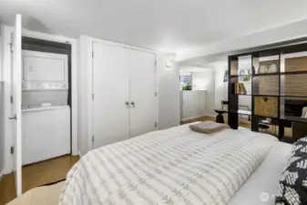 Bedroom with nearby laundry closet and room for dressers—simple, functional layout.