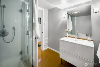 Fresh bathroom with glass-enclosed shower, modern vanity, and clean, neutral finishes.